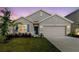 Charming one-story home with a well-manicured lawn, inviting curb appeal, and a two-car garage at 8210 Juning Cv, Wesley Chapel, FL 33545