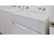 Laundry room with a white Whirlpool washer and dryer, providing efficient laundry solutions at 8210 Juning Cv, Wesley Chapel, FL 33545