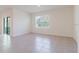 Bright living room with ceramic tile, a large window, and access to the outdoors at 8210 Juning Cv, Wesley Chapel, FL 33545