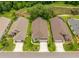 Aerial view of the houses with neatly manicured lawns, driveways, and landscaping in a lovely neighborhood at 9751 Conservation Dr, New Port Richey, FL 34655