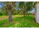 Expansive backyard with mature trees providing shade and privacy at 9751 Conservation Dr, New Port Richey, FL 34655