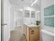 Bathroom featuring a modern vanity and sink, plus a laundry area viewable through the doorway at 9751 Conservation Dr, New Port Richey, FL 34655