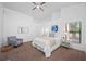 Bright bedroom with a ceiling fan, a comfortable chair and white bedding at 9751 Conservation Dr, New Port Richey, FL 34655