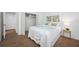 Cozy bedroom with soft carpet, closet, and a bedside table with lamp at 9751 Conservation Dr, New Port Richey, FL 34655