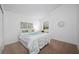 Bright bedroom with carpet floors, a window with natural light, and stylish decor at 9751 Conservation Dr, New Port Richey, FL 34655