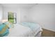 Bright bedroom featuring a window with natural light and views of the landscape at 9751 Conservation Dr, New Port Richey, FL 34655