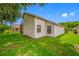 Well-maintained home exterior with a spacious yard and mature landscaping at 9751 Conservation Dr, New Port Richey, FL 34655