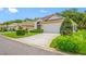 Inviting single-story home with lush landscaping and a well-kept lawn, offering great curb appeal at 9751 Conservation Dr, New Port Richey, FL 34655