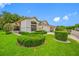 Attractive single-story home with vibrant landscaping and a well-manicured lawn at 9751 Conservation Dr, New Port Richey, FL 34655