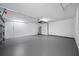 Spacious garage featuring a clean epoxy floor and ample room for vehicles and storage at 9751 Conservation Dr, New Port Richey, FL 34655
