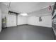 Spacious garage featuring a clean epoxy floor and ample room for vehicles and storage at 9751 Conservation Dr, New Port Richey, FL 34655
