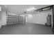 Spacious garage featuring a clean epoxy floor and ample room for vehicles and storage at 9751 Conservation Dr, New Port Richey, FL 34655