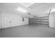 Spacious garage featuring a clean epoxy floor and ample room for vehicles and storage at 9751 Conservation Dr, New Port Richey, FL 34655