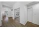 Bright hallway with wood floors and access to other rooms at 9751 Conservation Dr, New Port Richey, FL 34655