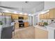 Kitchen with stainless steel appliances, wood cabinetry, and a view of the breakfast nook at 9751 Conservation Dr, New Port Richey, FL 34655