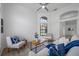 Bright, open living room with a high ceiling, ceiling fan, and a large window with natural light at 9751 Conservation Dr, New Port Richey, FL 34655