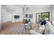 Open living room with vaulted ceiling and open view to the lanai at 9751 Conservation Dr, New Port Richey, FL 34655