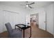 Home office featuring a ceiling fan, view to the living room and hallway, closet at 9751 Conservation Dr, New Port Richey, FL 34655