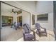 Spacious screened patio with ceiling fan, tile flooring and comfortable seating furniture at 9751 Conservation Dr, New Port Richey, FL 34655