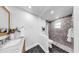 Bathroom featuring tiled shower, hexagon tile floor, and a vessel sink on a marble countertop at 9903 Saddle Rd, Tampa, FL 33626