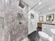 Bathroom featuring step-in shower, a vanity with double sinks, and stone and tile floors at 9903 Saddle Rd, Tampa, FL 33626