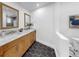 Bright bathroom featuring a dual sink vanity, black hexagon tiles, and modern fixtures at 9903 Saddle Rd, Tampa, FL 33626