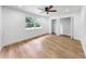Bright bedroom featuring wood floors, a ceiling fan, and closets at 9903 Saddle Rd, Tampa, FL 33626