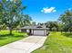 Charming single-story home with a well-manicured lawn, long driveway and attached garage at 9903 Saddle Rd, Tampa, FL 33626