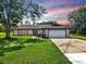 Beautiful home with a well-manicured lawn and driveway at 9903 Saddle Rd, Tampa, FL 33626