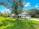 Charming single-story home with a well-manicured lawn, long driveway and attached garage at 9903 Saddle Rd, Tampa, FL 33626