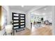 Bright foyer featuring modern double doors, stylish decor, and wood-look tile flooring at 9903 Saddle Rd, Tampa, FL 33626
