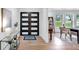 Bright foyer featuring modern double doors, stylish decor, and wood-look tile flooring at 9903 Saddle Rd, Tampa, FL 33626