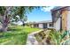 View of a home with a landscaped front yard and walkway at 9903 Saddle Rd, Tampa, FL 33626