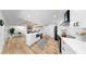 Open-concept kitchen with white cabinetry, stainless appliances, and an island open to the living area at 9903 Saddle Rd, Tampa, FL 33626