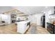 Modern kitchen with stainless steel appliances, large island, and open layout to living room at 9903 Saddle Rd, Tampa, FL 33626