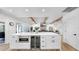 Kitchen island with marble countertop, microwave, wine fridge, and additional storage at 9903 Saddle Rd, Tampa, FL 33626