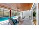 Outdoor lanai has covered seating, a ceiling fan, and a view of the screened-in pool at 9903 Saddle Rd, Tampa, FL 33626