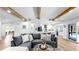 Open-concept living room with wood beams, modern decor, and seamless flow to the kitchen at 9903 Saddle Rd, Tampa, FL 33626