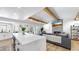 Open floor plan with a large kitchen island overlooking the living area with fireplace and TV at 9903 Saddle Rd, Tampa, FL 33626