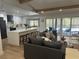 Open-concept living area with modern kitchen, large island, and seamless access to a screened-in outdoor pool at 9903 Saddle Rd, Tampa, FL 33626