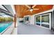 Outdoor space features a pool and lanai with seating area, ceiling fan and bright surroundings at 9903 Saddle Rd, Tampa, FL 33626