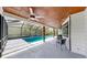 Outdoor living space with covered seating area, ceiling fan and screened-in pool at 9903 Saddle Rd, Tampa, FL 33626