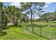 Fenced backyard with mature trees providing shade, ideal for outdoor activities and relaxation at 1443 54Th Ne Ave, St Petersburg, FL 33703