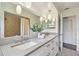Bathroom features double sinks, granite counters, and a shower at 1443 54Th Ne Ave, St Petersburg, FL 33703