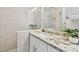 Close up of bathroom featuring granite countertop, updated fixtures, and tiled shower at 1443 54Th Ne Ave, St Petersburg, FL 33703