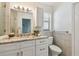 Well-lit bathroom with modern vanity, granite countertops, and updated fixtures at 1443 54Th Ne Ave, St Petersburg, FL 33703