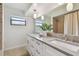 Bathroom features double sinks, granite counters, and a shower at 1443 54Th Ne Ave, St Petersburg, FL 33703