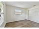 Bedroom with wood floors features a closet and a window at 1443 54Th Ne Ave, St Petersburg, FL 33703