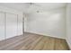 Bedroom features wood floors and a closet with double doors at 1443 54Th Ne Ave, St Petersburg, FL 33703