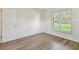 Bright bedroom features wood floors and plantation shutters at 1443 54Th Ne Ave, St Petersburg, FL 33703